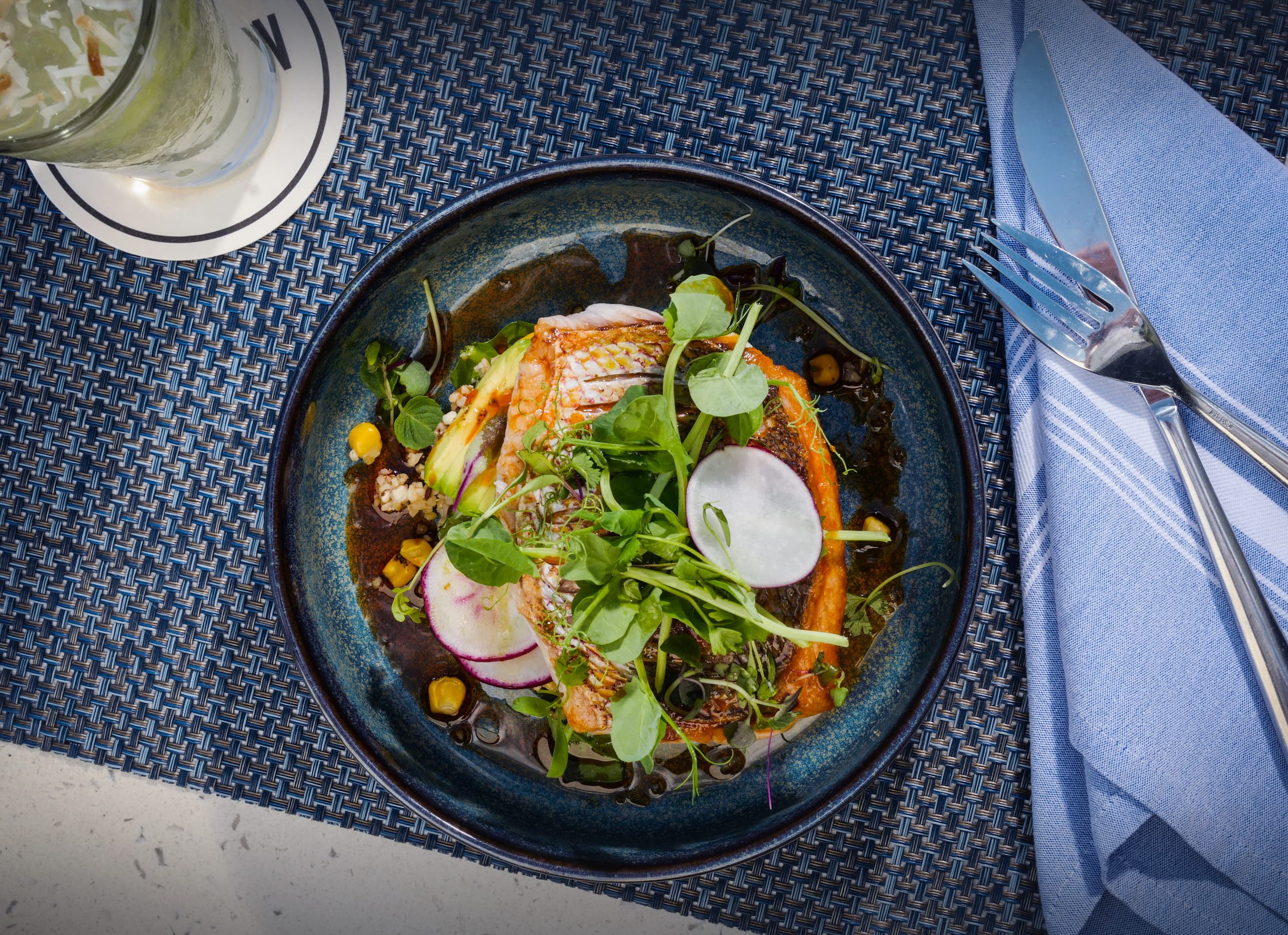 A salmon dish with veggies at BALEEN restaurant