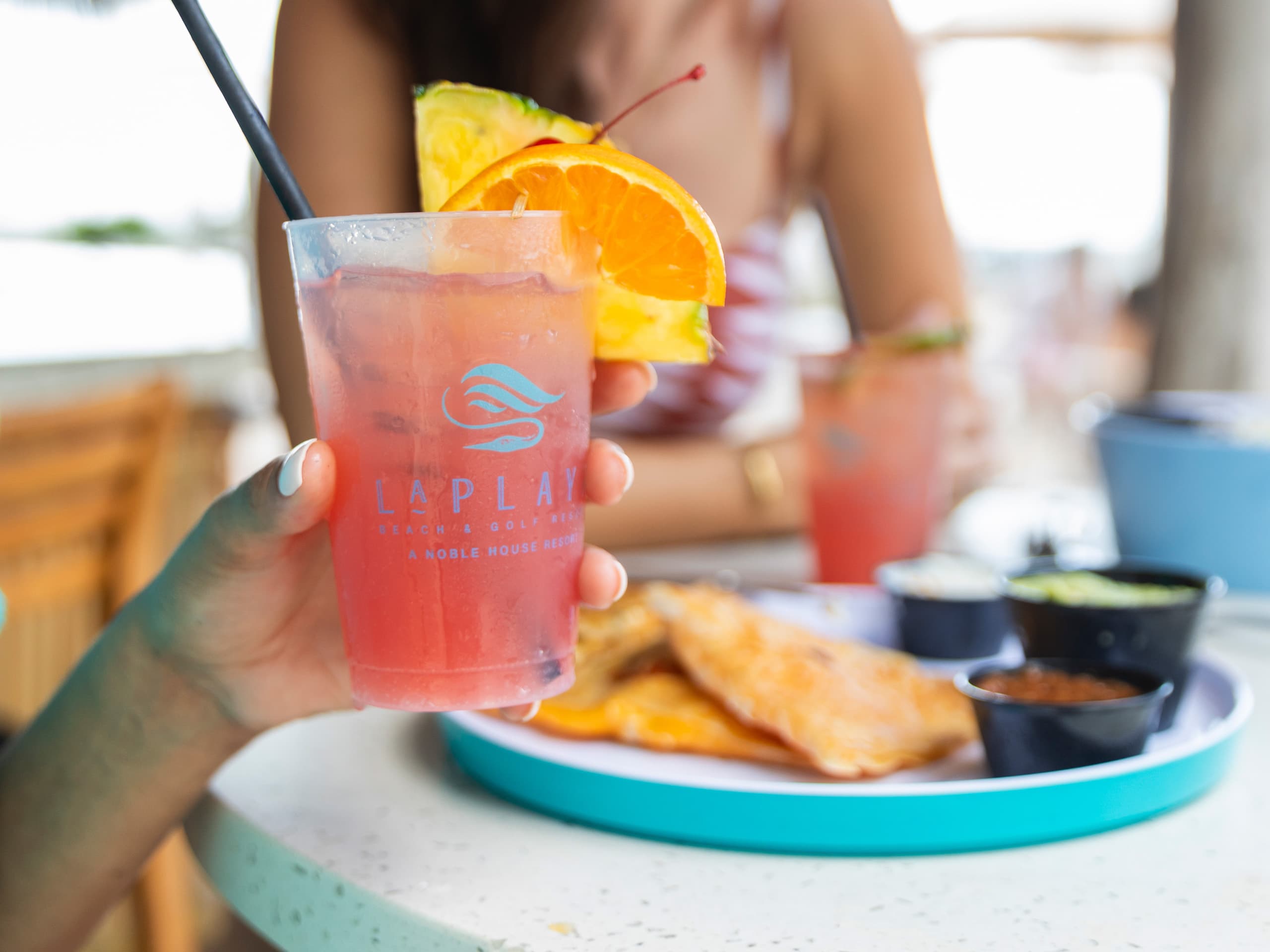 A cold, pink cocktail at LaPlaya Poolside Tiki Bar