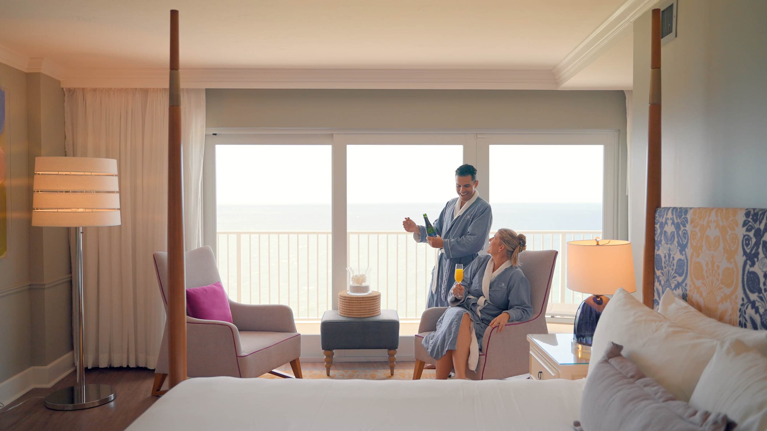 A couple in robes have a mimosa
