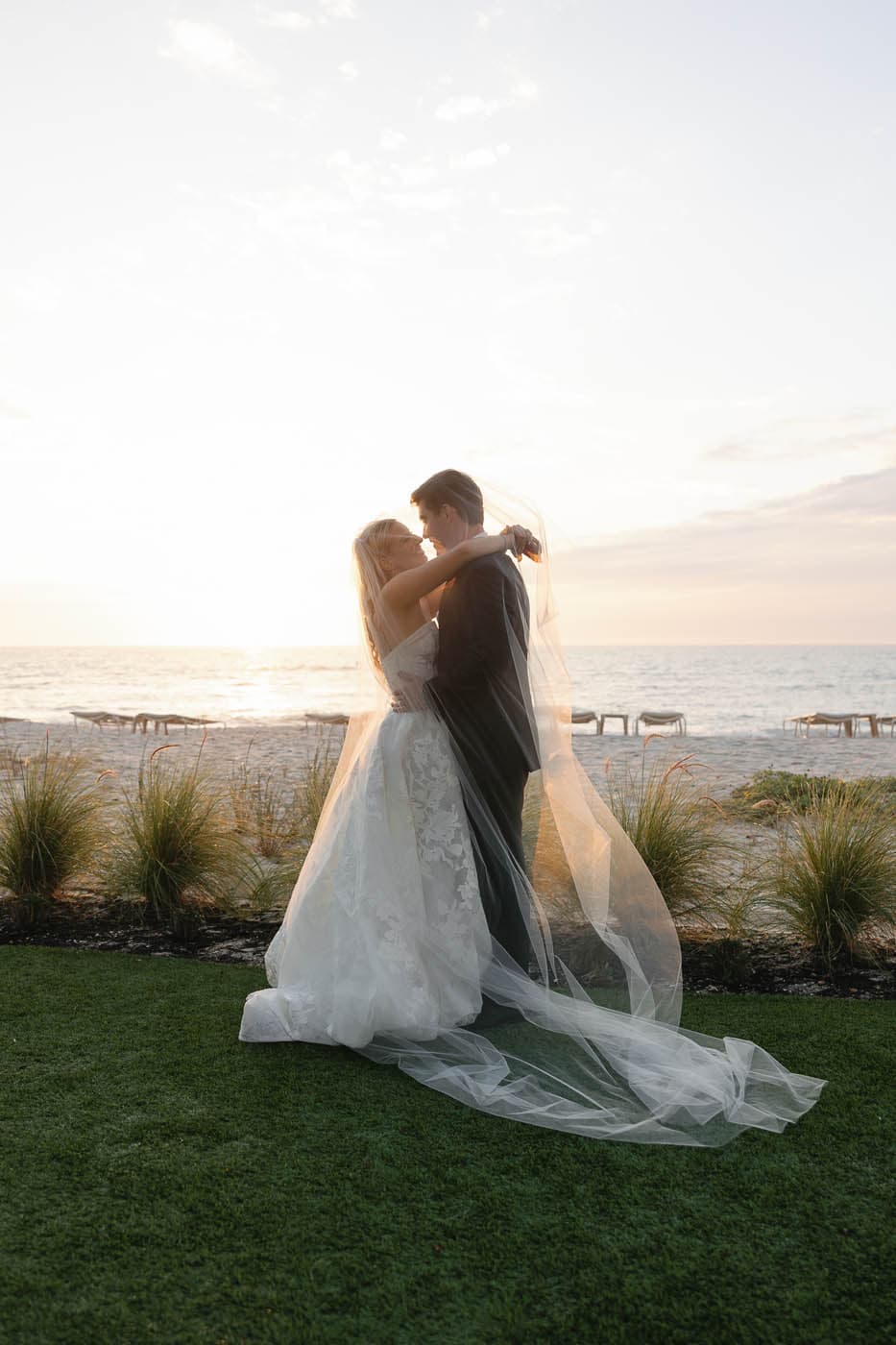 A just married couple embracing in the sunset at LaPlaya