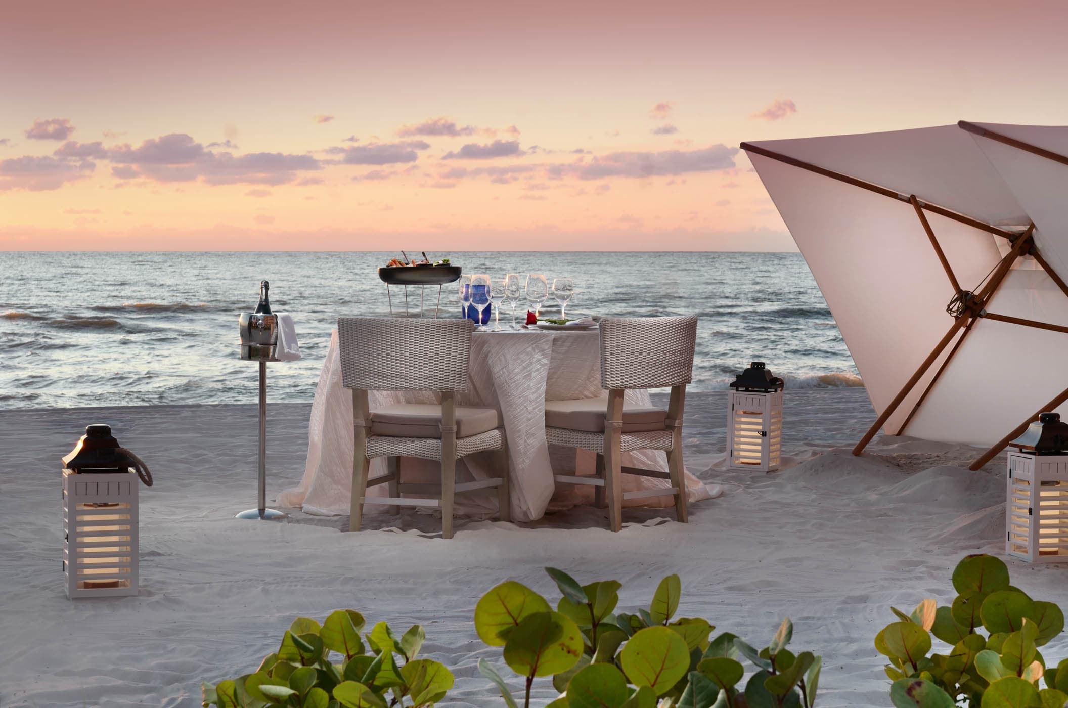 A small table setup for a romantic dinner on the beach at LaPlaya