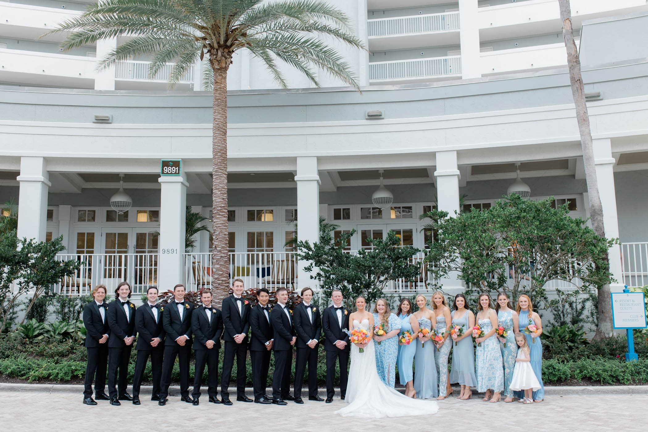 A wedding party getting a photo taken out front of LaPlaya