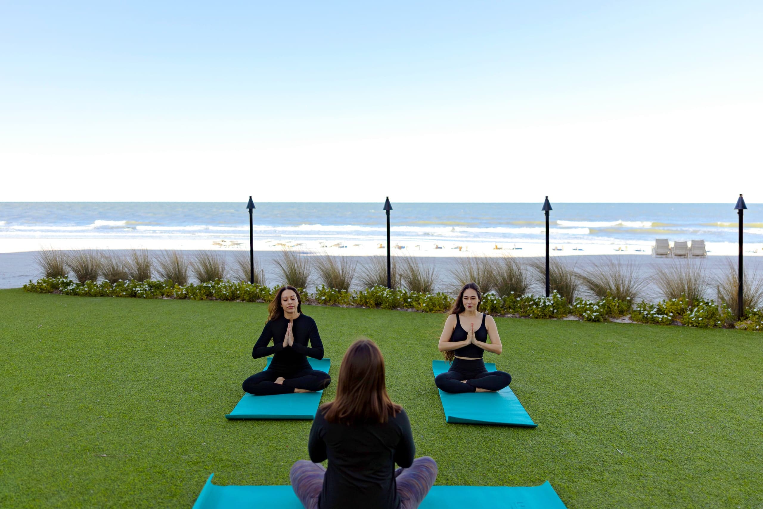 3 people doing yoga at LaPlaya