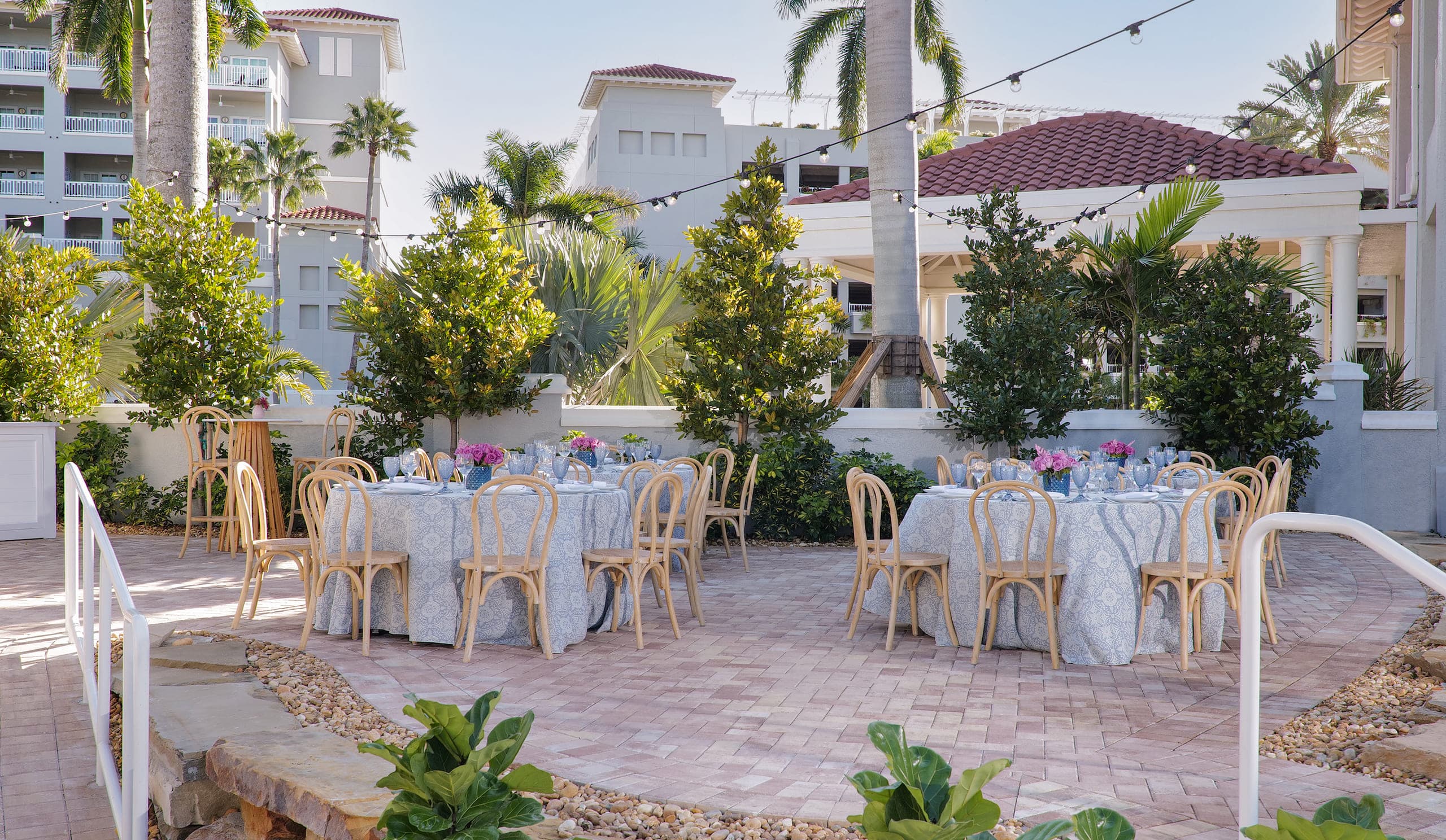 4 tables set up for an event outside at LaPlaya
