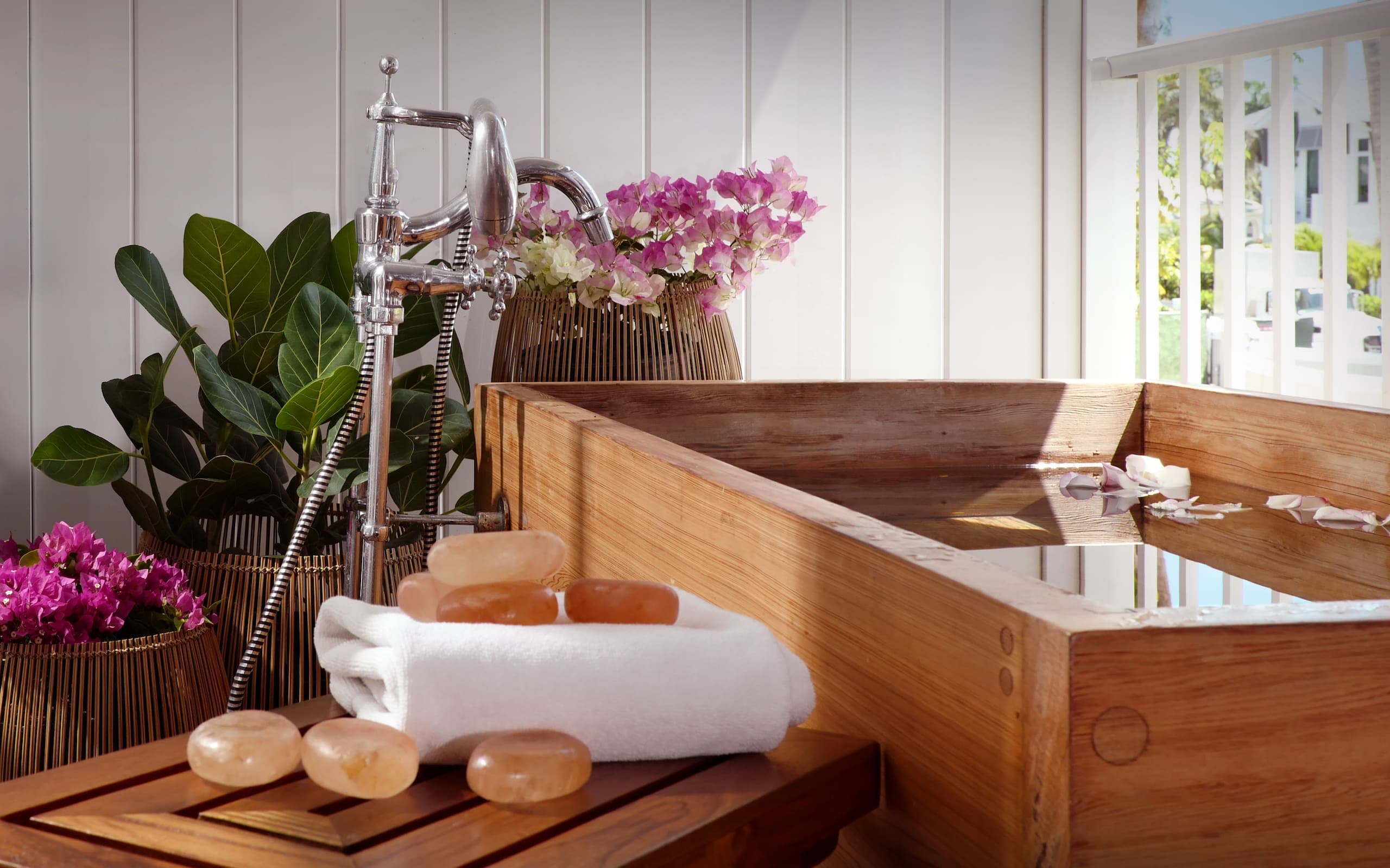 SpaTerre Naples with beautiful flowers and plants, a wooden soaker tub and plenty of soaps