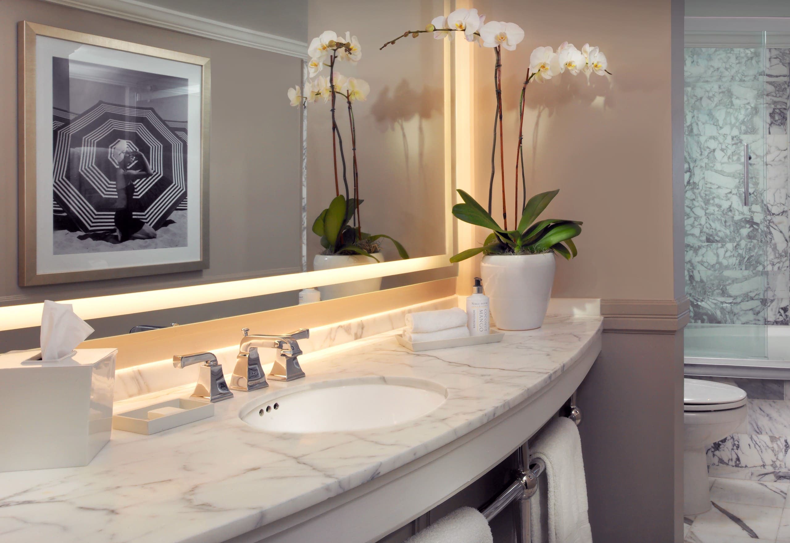 A marble vanity with full mirror lighting in a Laplaya Beach Front King room