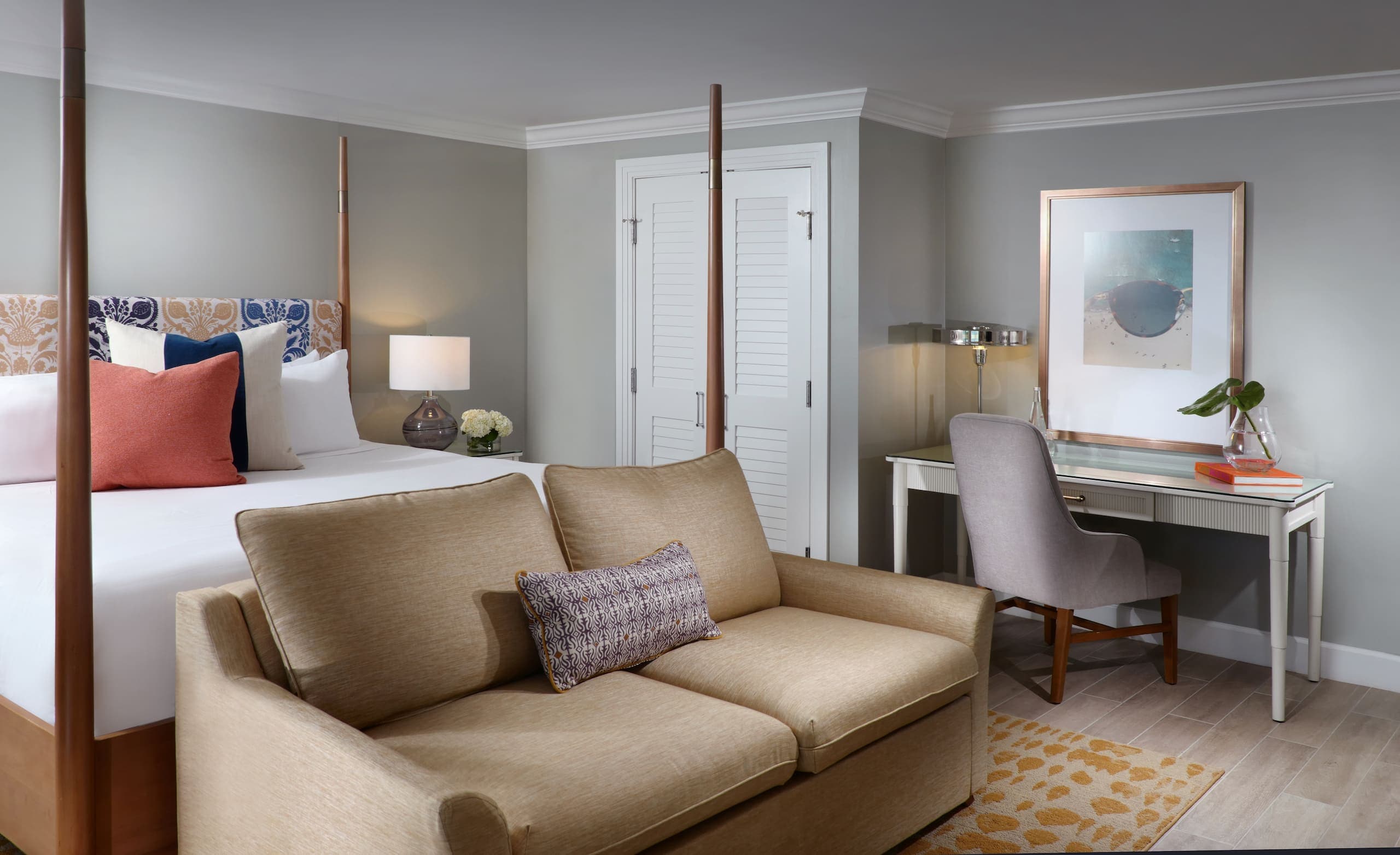 A king bed, couch and desk in a laPlaya Beachfront lanai room