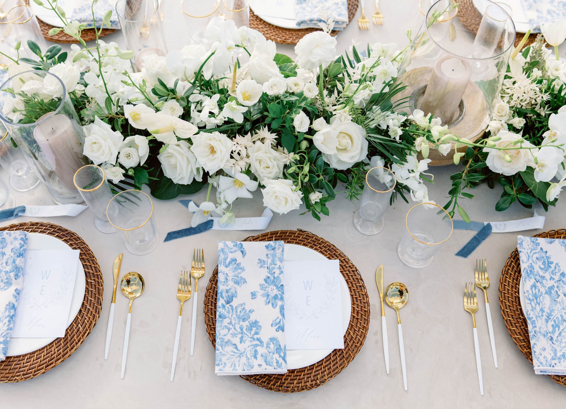A wedding dinner place setting with gorgeous bouquets of flowers