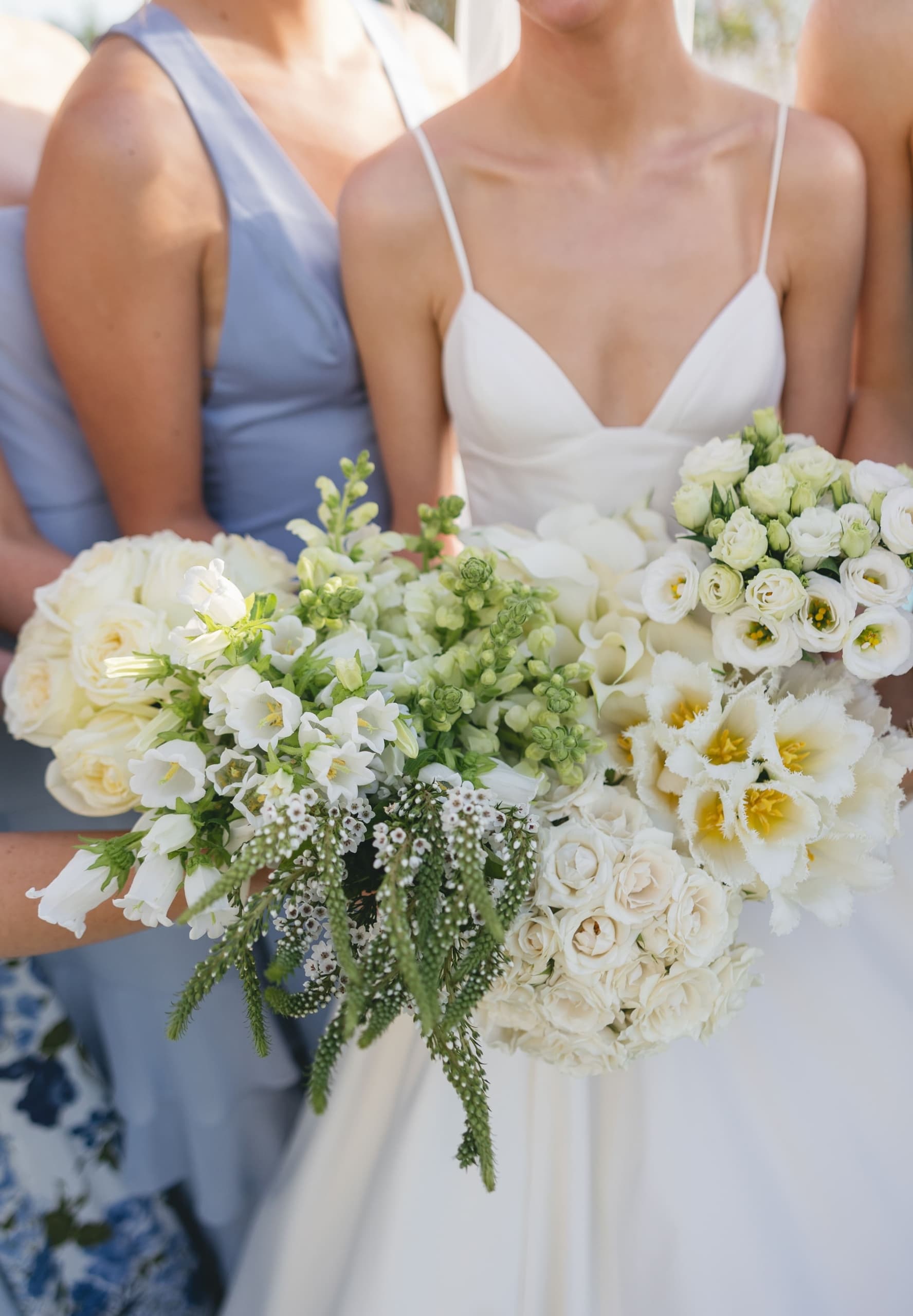 A bride holding a large bouquet of flowers