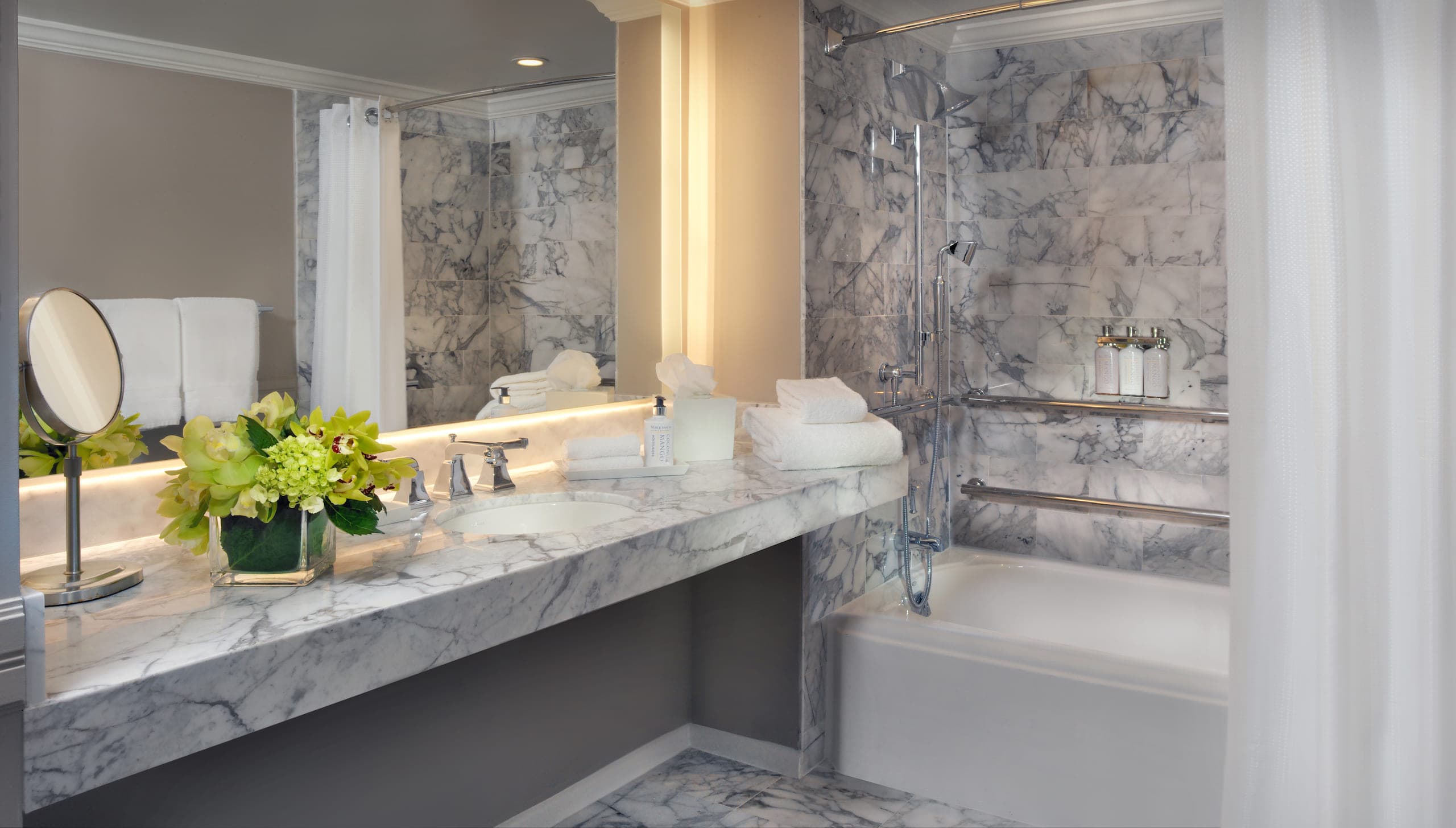 A marble tiled bathroom in a Gulf Tower Suite at LaPlaya