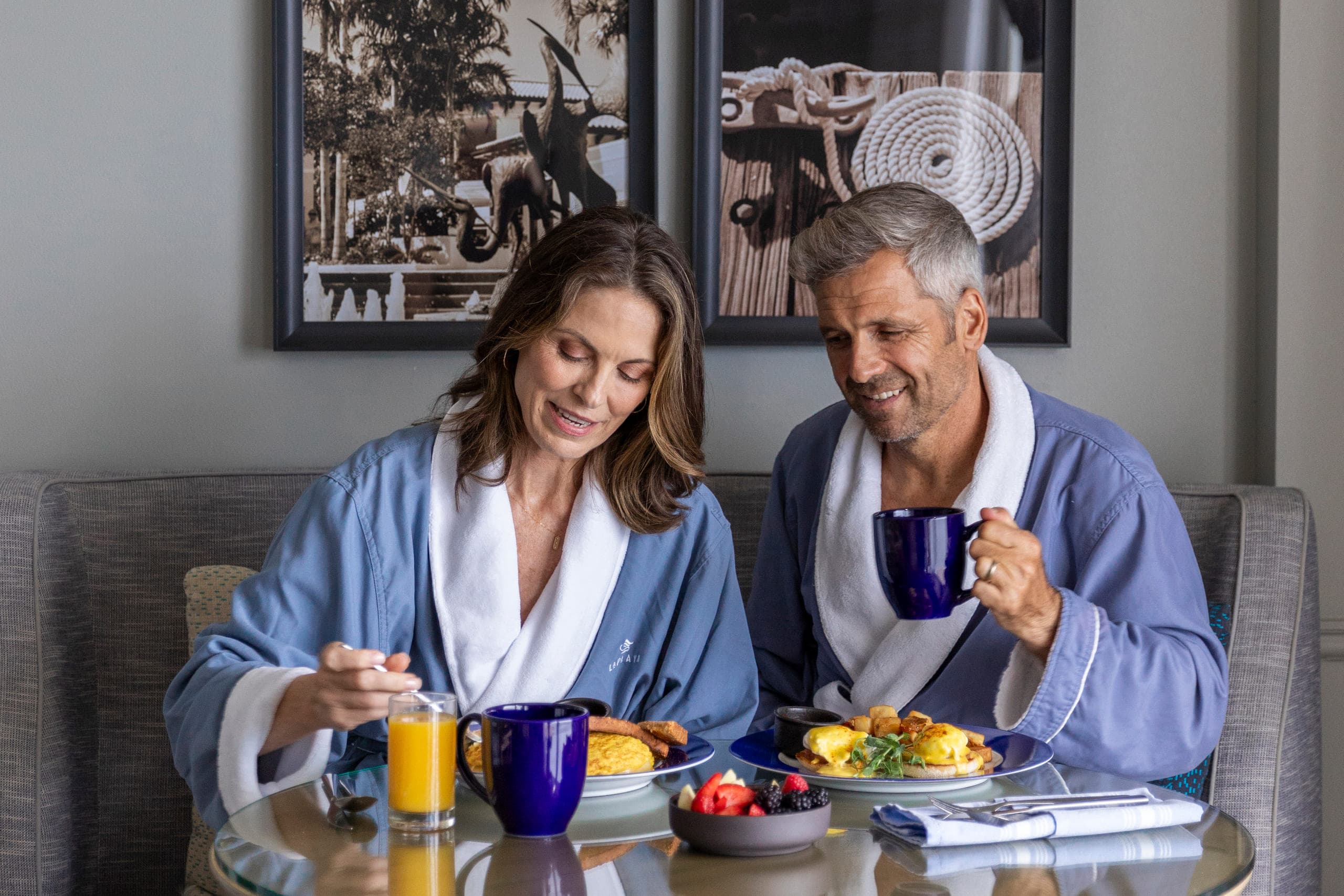 A couple enjoying their in-room dining breakfast