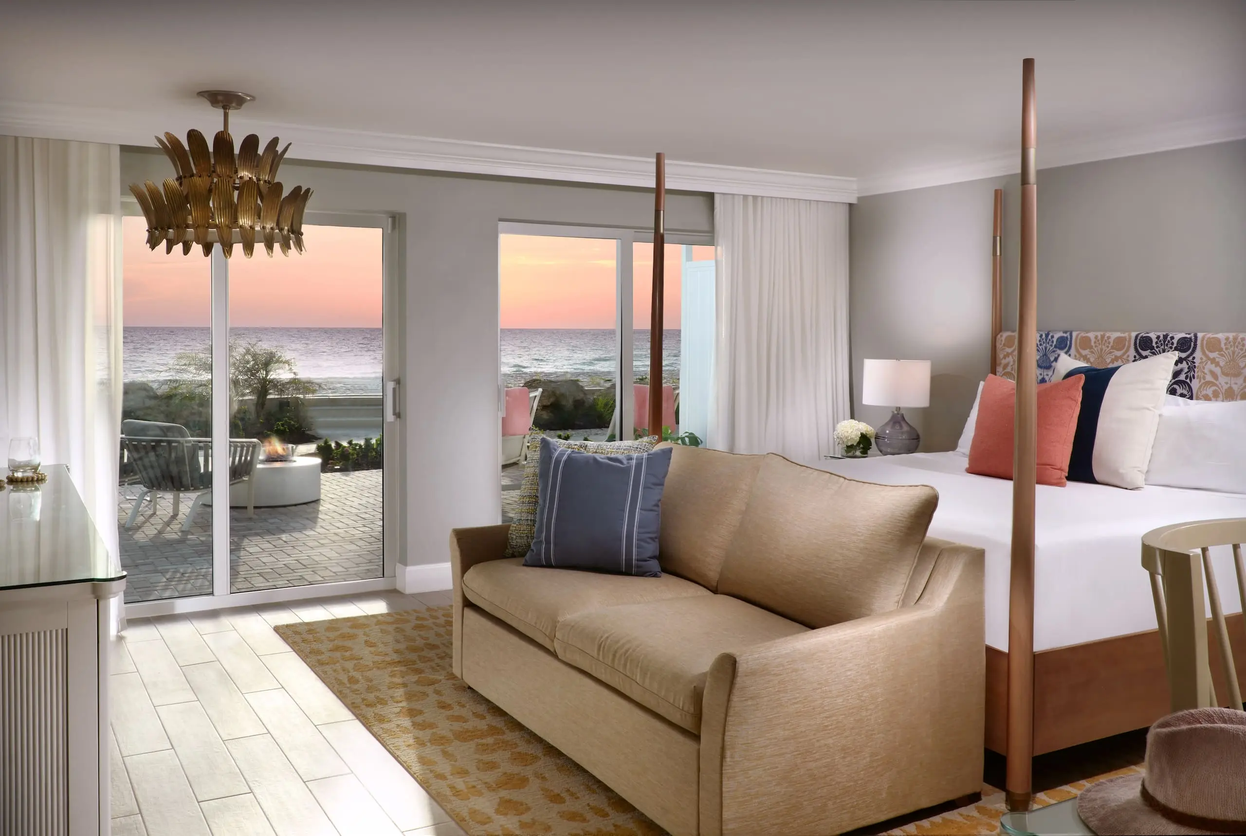 Laplaya Beach House room with a king bed, couch and beachfront patio