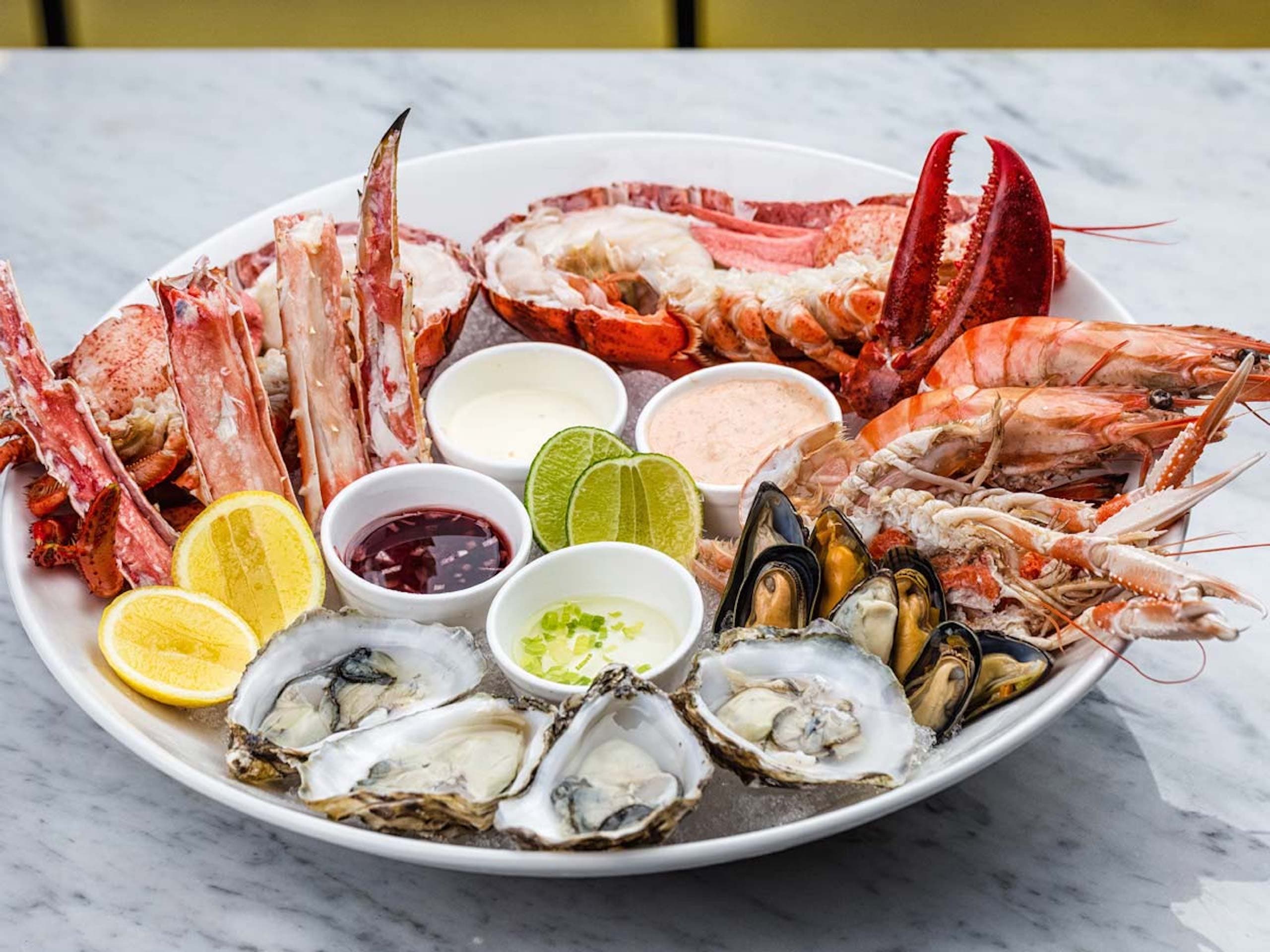 A seafood plate with lobster, crab, oysters and clams