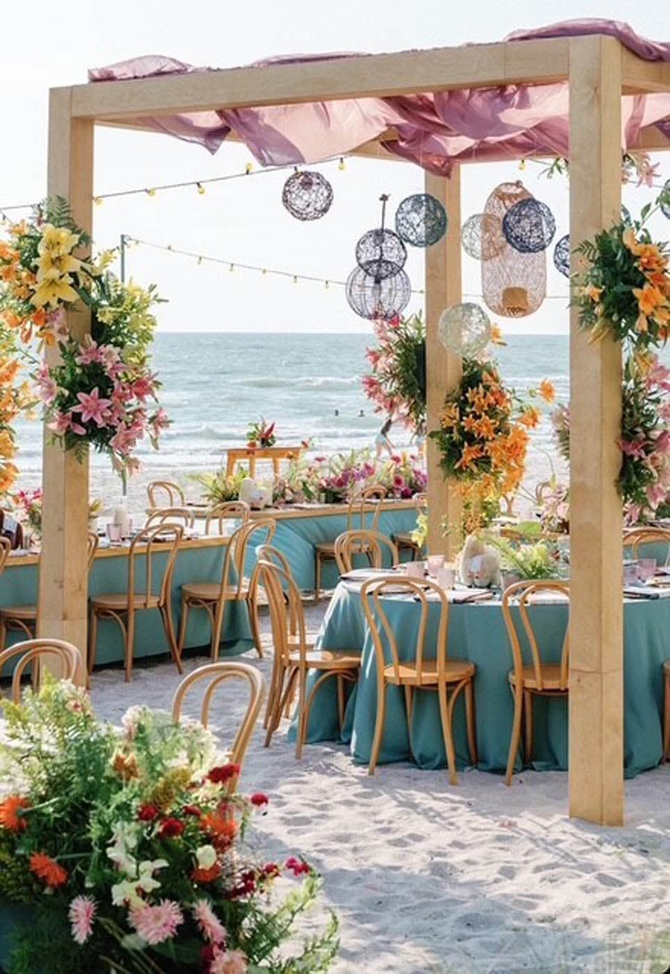A wedding dinner setup on the beach at LaPlaya