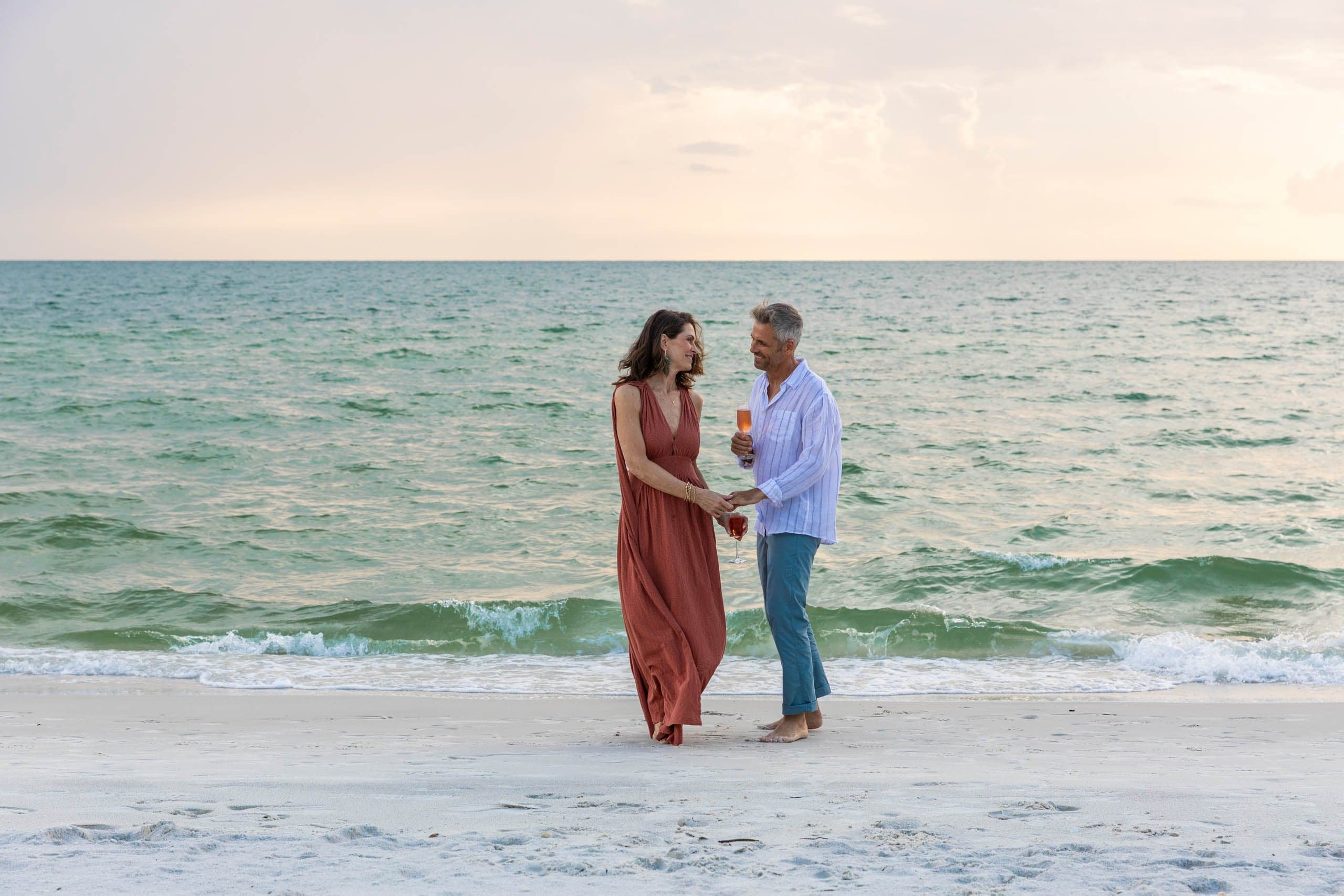 A couple on the beach having wine at LaPlaya