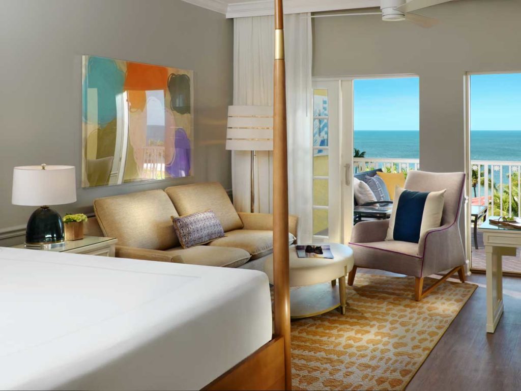 Signature Room with king sized bed sitting area and balcony