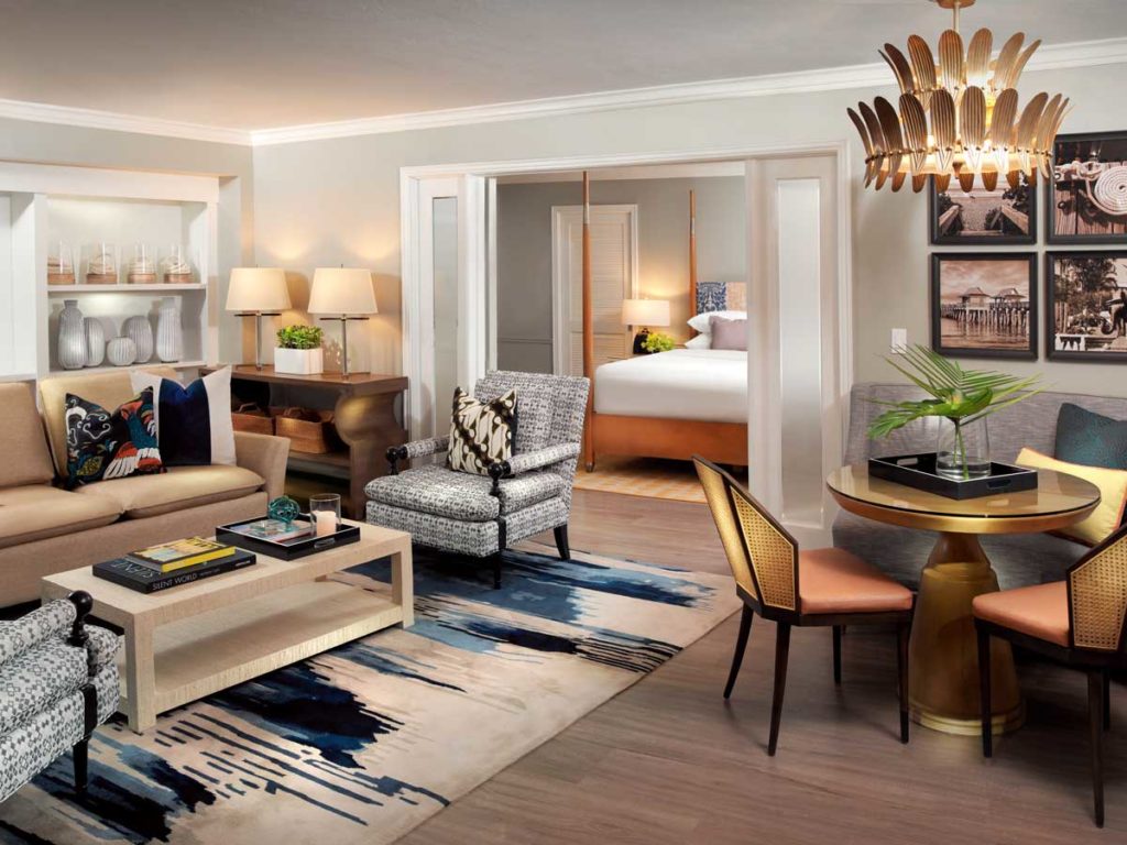 Bedroom suite with sitting area, dining area, and bedroom in Naples, FL