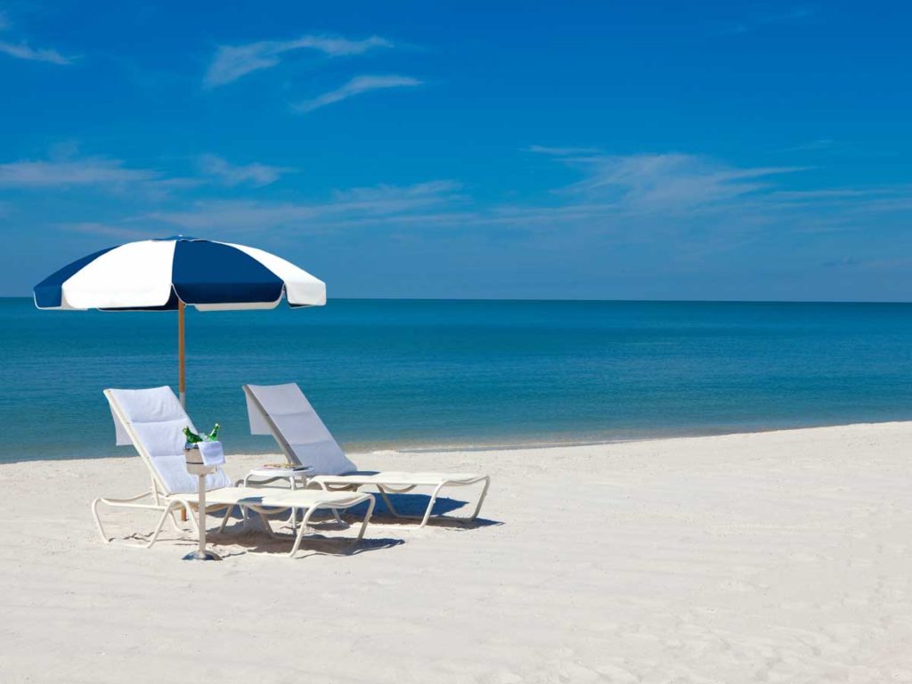 Beach Chairs, drinks and umbrella at Naples, Florida private beach