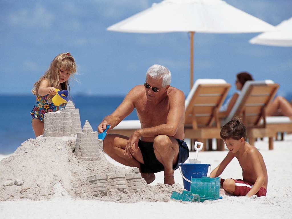 Family building sandcastle on Naples, FL beach