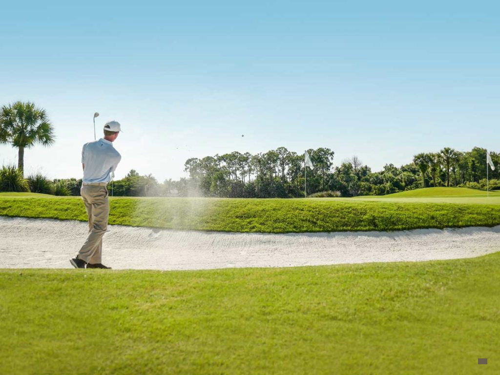 Golfer by sand trap at Naples Florida Beach Golf Course