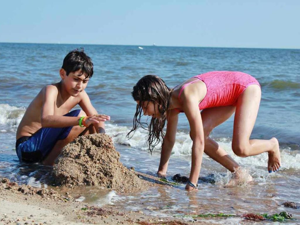 Kids building sancastle on La Playa Beach and Golf Resort beach