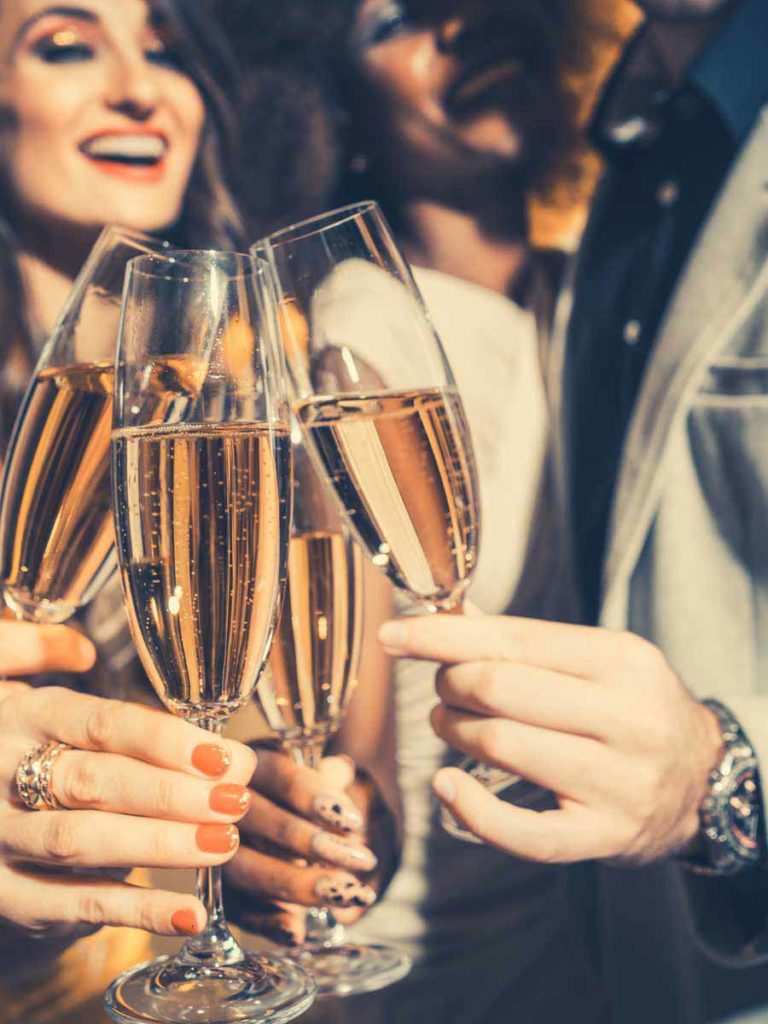 people celebrating with champagne glasses