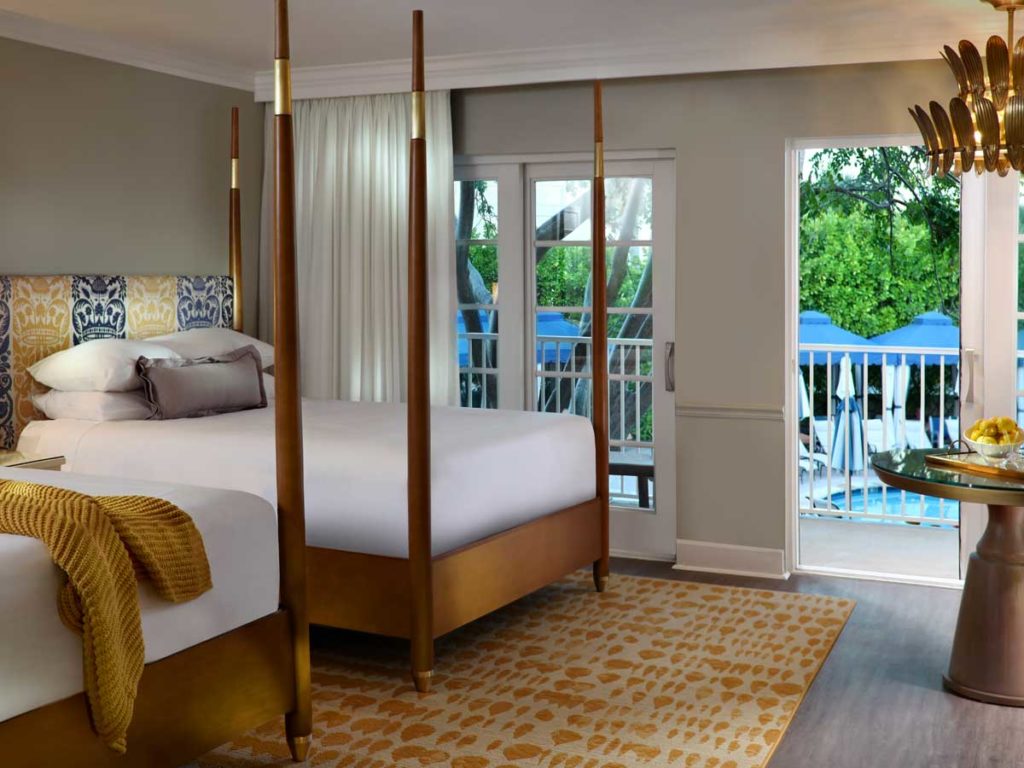 Guestroom with 2 queen sized beds and access to pool in Naples, FL