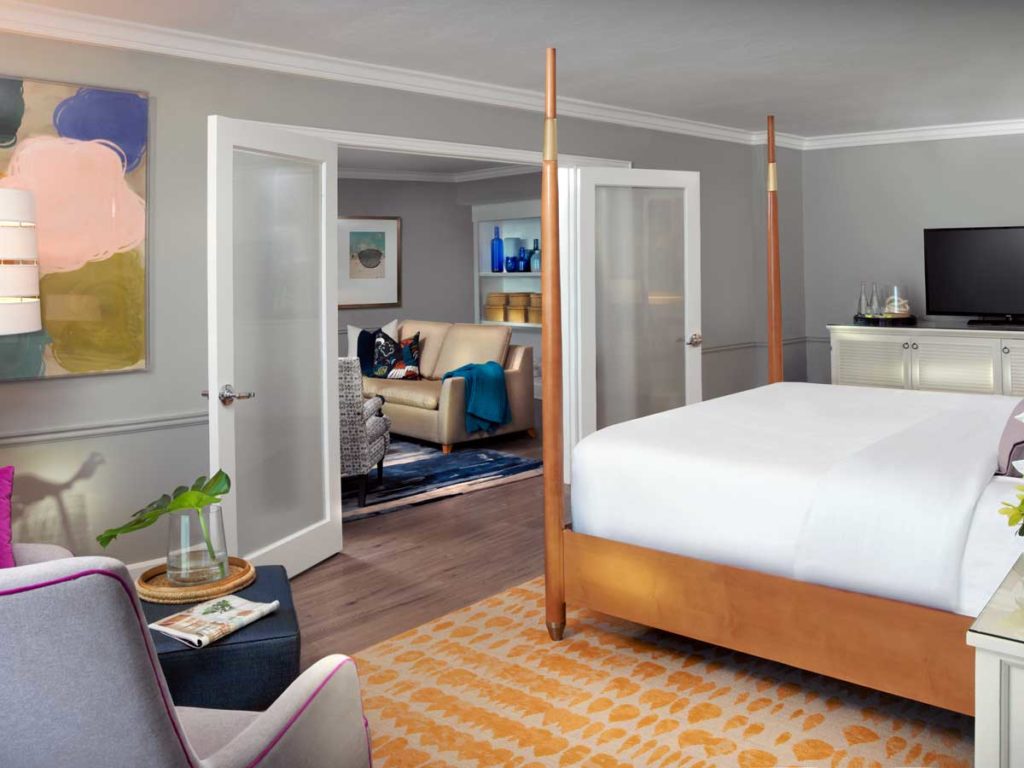 Naples FL hotel room suite with sitting area and king sized bed
