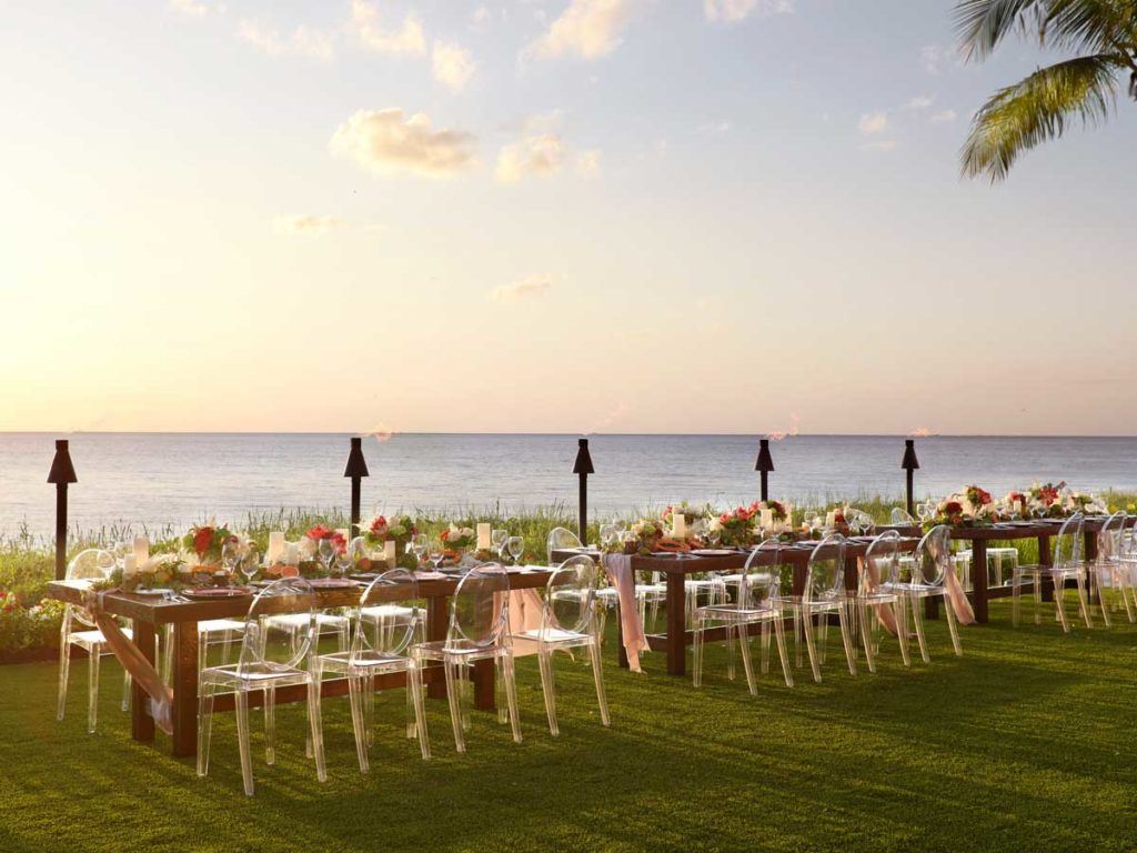 long picnic table style on lawn facing the ocean
