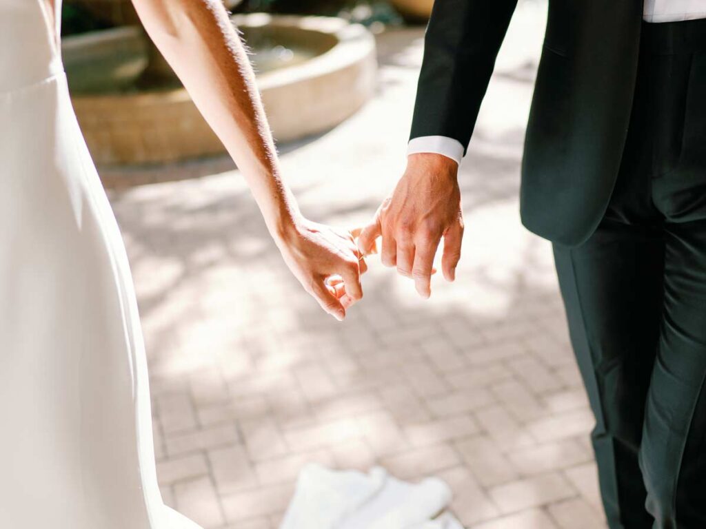 Bride And Groom Holding Hands.