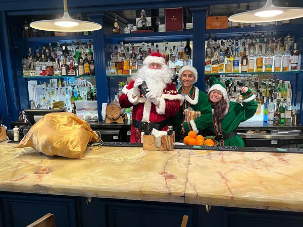 Bartenders Dressed Up As Santa And Elves