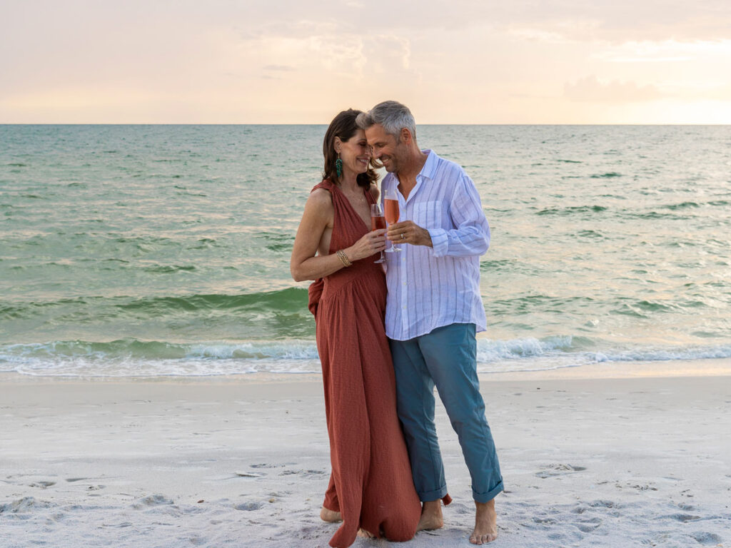 Couple With Champagne On The Beach
