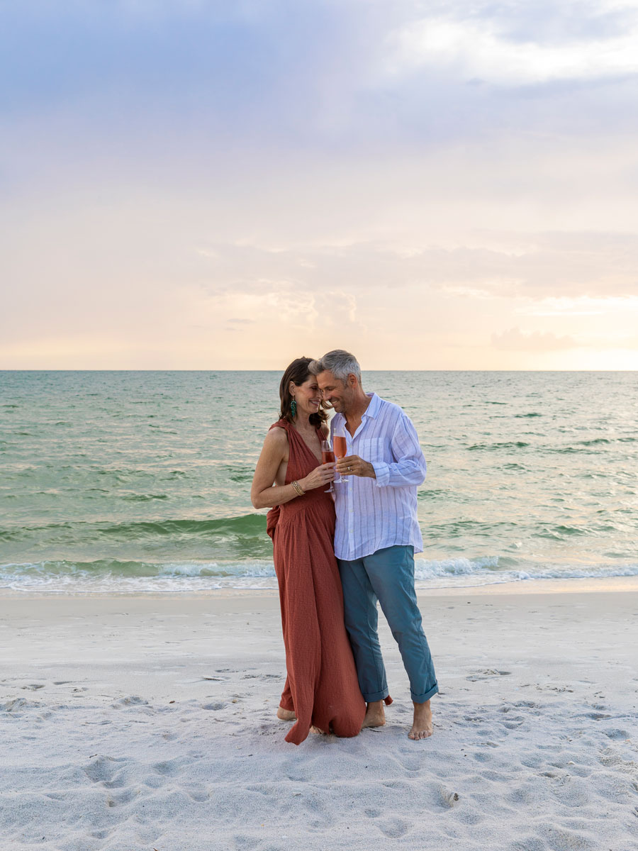 Couple With Champagne On The Beach